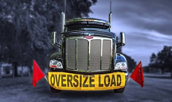 Oversized Load Truck Front View with Warning Banners and Flags